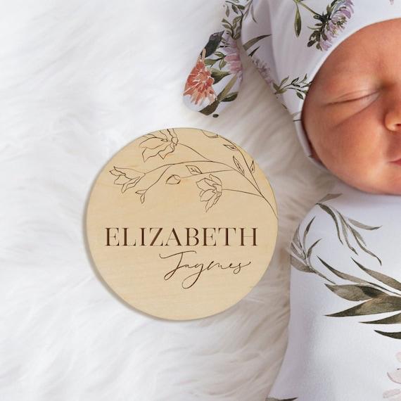 Wooden name plaque with Elizabeth Jaymes engraved, placed with baby